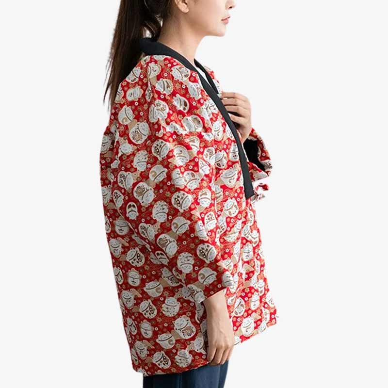 A woman dressed with a red japanese coat Hanten pattern with whit lucky cat