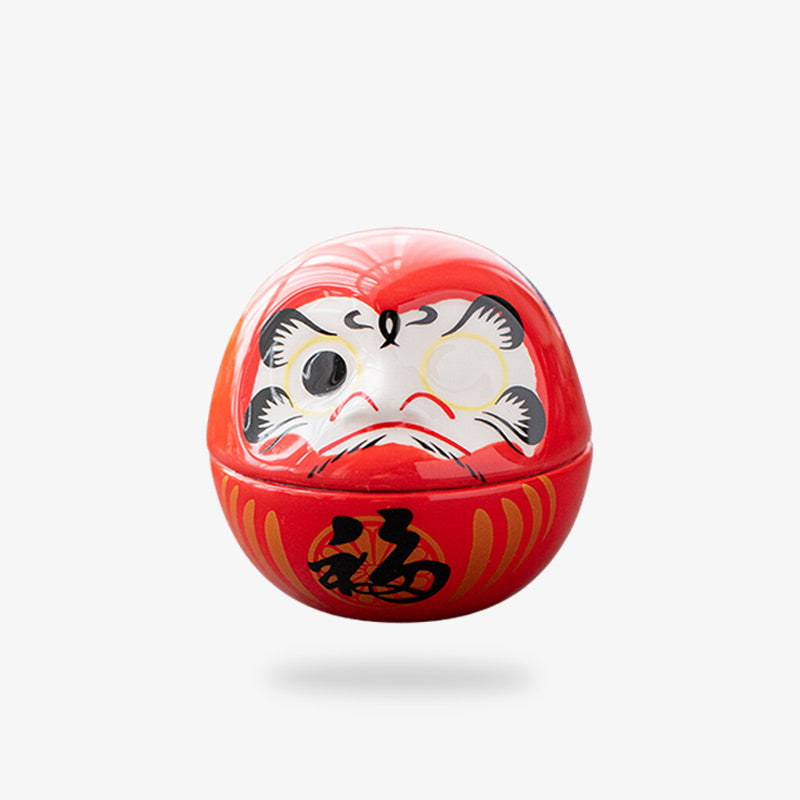 the red daruma is japanese lucky charm use as a home decor. It is paintd with red color and black kanji