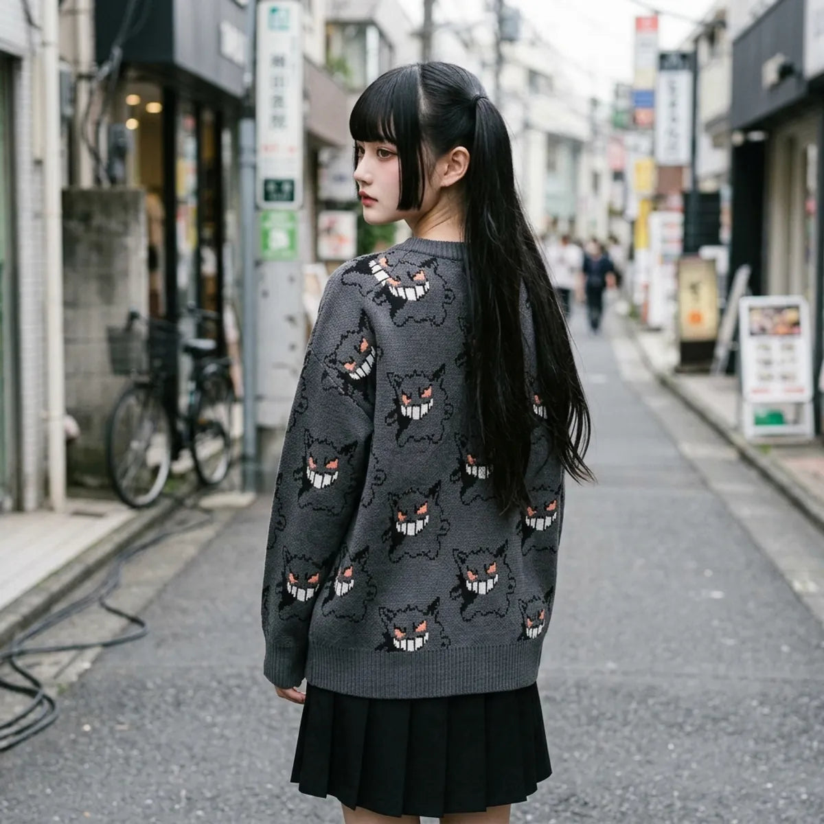 Gray sweater displayed from behind showing the ghost face pattern continuing across the back and sleeves