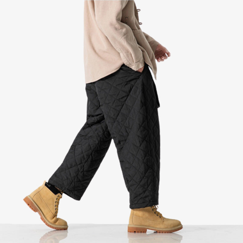 For the best streetwear outfit, dress up with japanese brand cargo pants. The man is dressed with synthetic black wide leg pants.