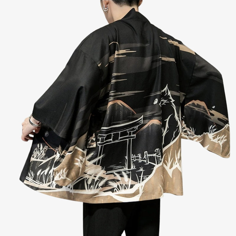 Person wearing a black kimono with landscape design on a white background