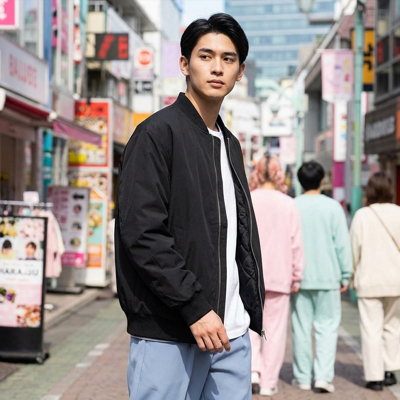 Man in a black Sukajan jacket standing on a busy Harajuku street with colorful signs and people in the background