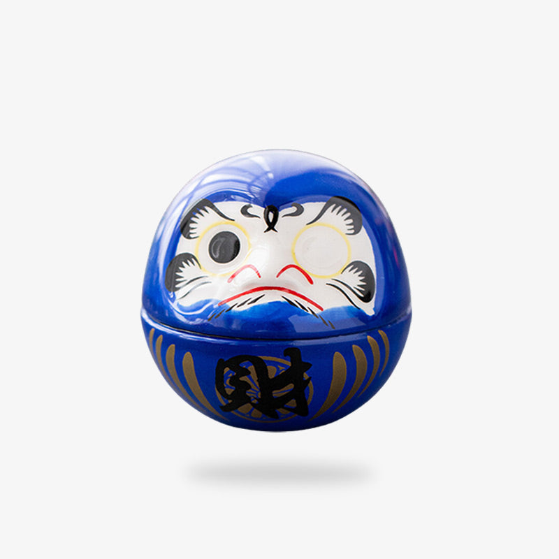 This blue daruma is painted with one black eye and kanji.