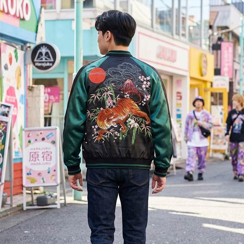 Man wearing a bomber jacket green with a Tiger design in a Harajuku setting
