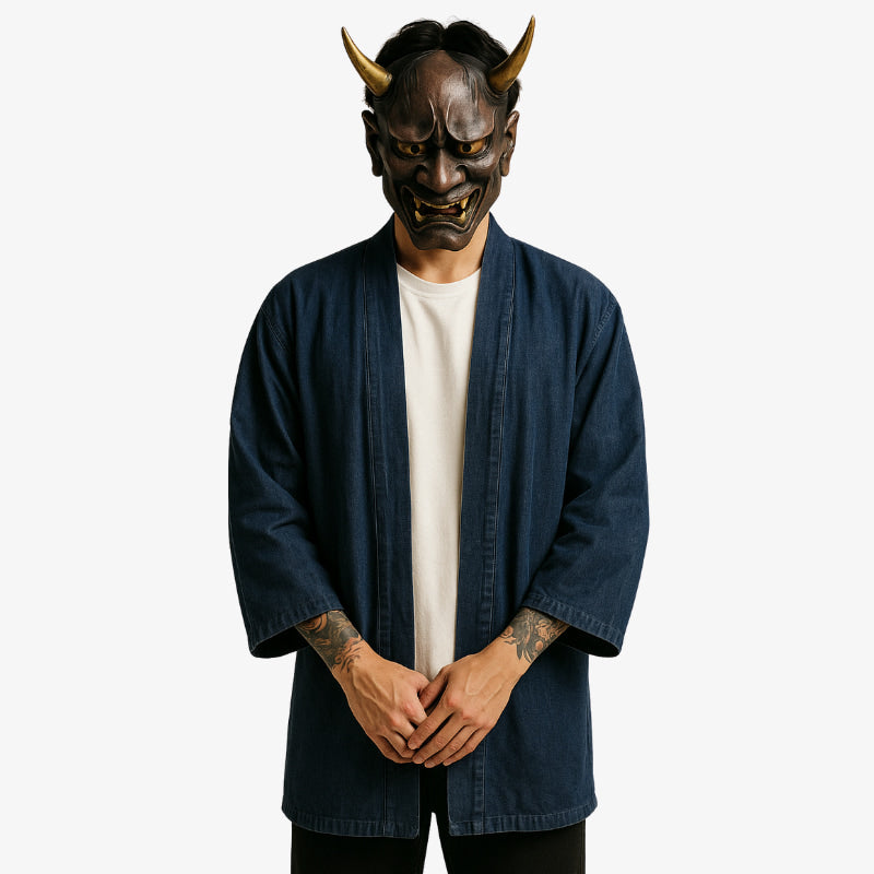 a japanese mam is dressed with a denim kimono, a white harajuku shirt made with cotton and a black japanese pants. His face is hidden by a red traditional Hannya mask