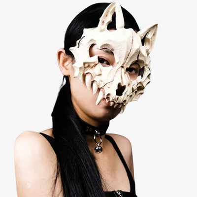 a woman wears a fox japanese mask. The japanese fox mask is white color, with a bones styles.