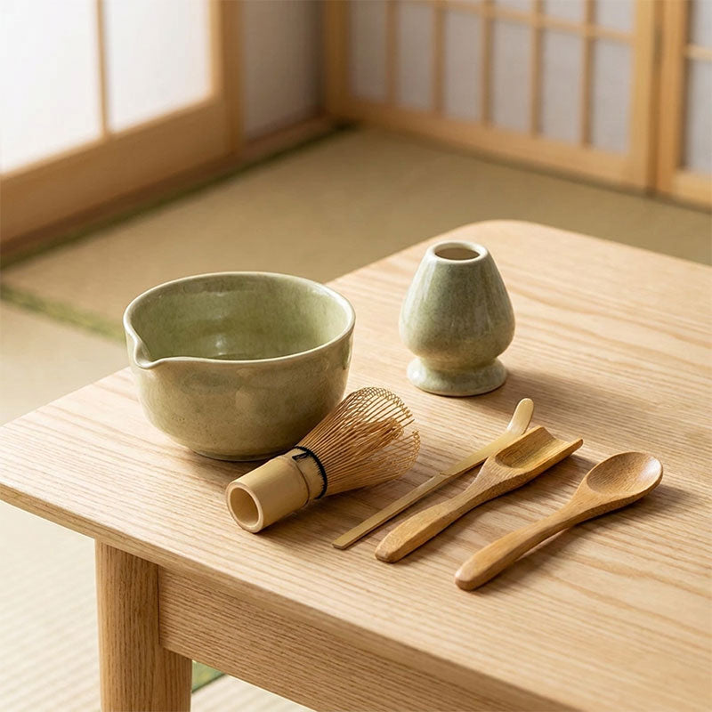 Green Matcha Whisk Set with wooden utensils on a wooden table in a japanese room with sliding doors.