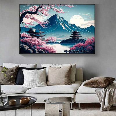 This Japanese cultural landscape wall decor object is a japanese landscape painting on mount fuji hung in a living room with a sofa and coffee table.