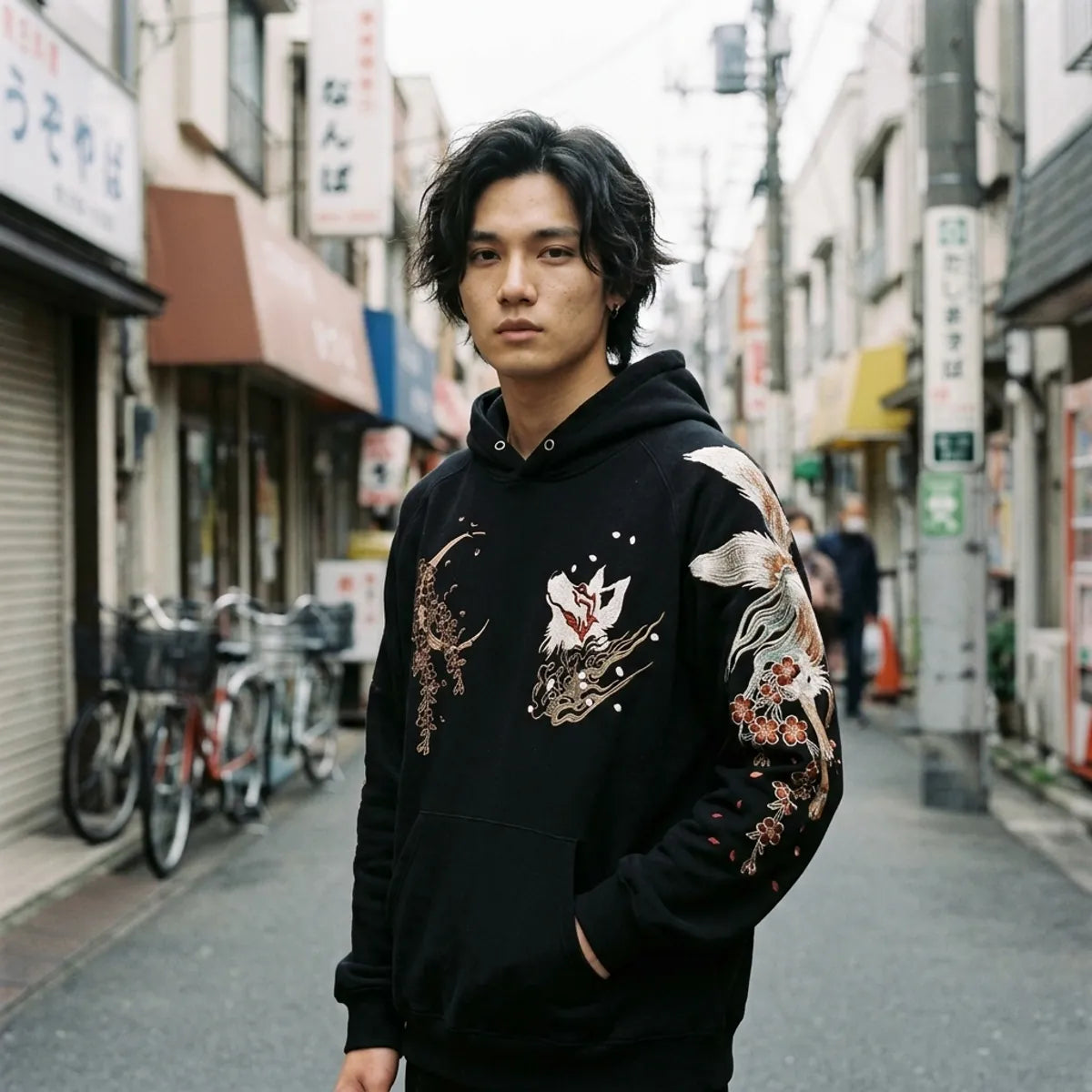 Japanese embroidered hoodie in black with a small kitsune fox head and a bronze moon on the chest