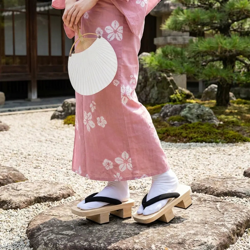 Japanese Geta Sandals worn with a pink kimono in a Japanese garden