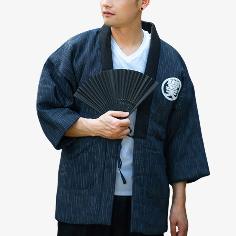 A person wearing a traditional Japanese Hanten coat with a straight cut design, holding a fan, featuring a black and white striped pattern with a small kanji symbol on the left chest area.