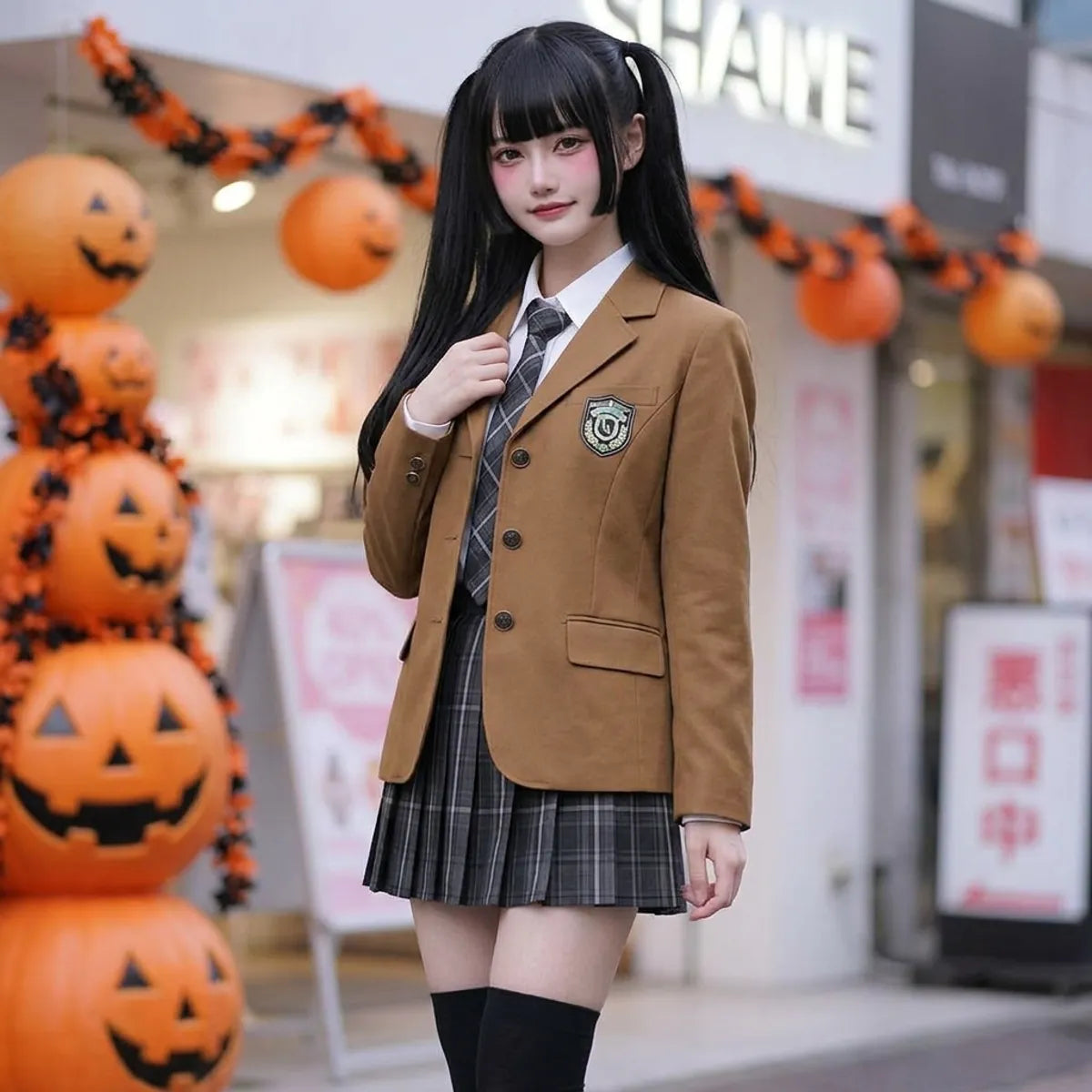 Full outfit shown together: camel blazer, white shirt, plaid tie and pleated plaid mini skirt