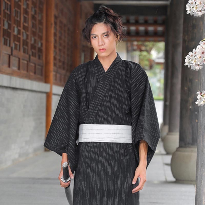 For a samurai look, buy japanese-silk-kimono-robe-mens. This Japanese man is holding a katana sword. Black japanese kimono with cotton and silk material