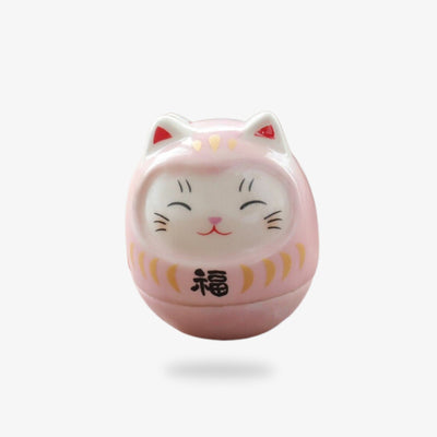 A kawaii maneki neko japanese lucky charm made of ceramic in the shape of a cute cat's head.