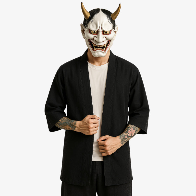 a man is dressed with a black Kimono mens cardigan inspired by haori design, combining Japanese heritage with casual modern fashion. The man wears a white traditional japanese mask on his face. The kimono jacket is made with quality cotton and long sleeves