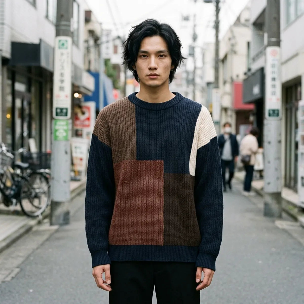 Navy blue oversized sweater with brown and cream colorblock panels shown from the front