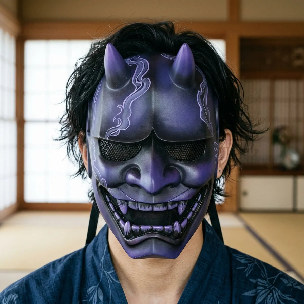 Front-facing view of the Japanese hannya demon mask in its purple-to-black ombre finish, showing the curved horns, furrowed brow and black steel mesh eye plates.