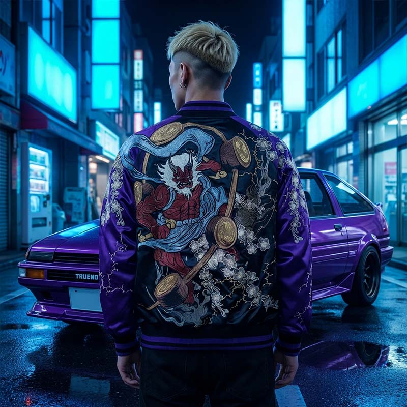 Man wearing a purple raijin and fujin jacket with intricate Japanese designs in an urban Japanese setting at night.