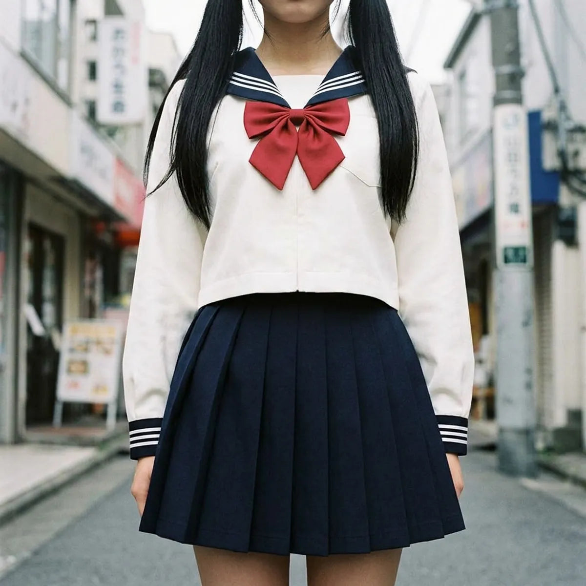 Close view of the navy sailor collar with white stripes and cuffed sleeves