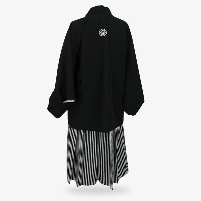 Sendaihira fabric featured in the striped hakama pants worn with a black Japanese kimono and haori jacket, blending durability and cultural authenticity.