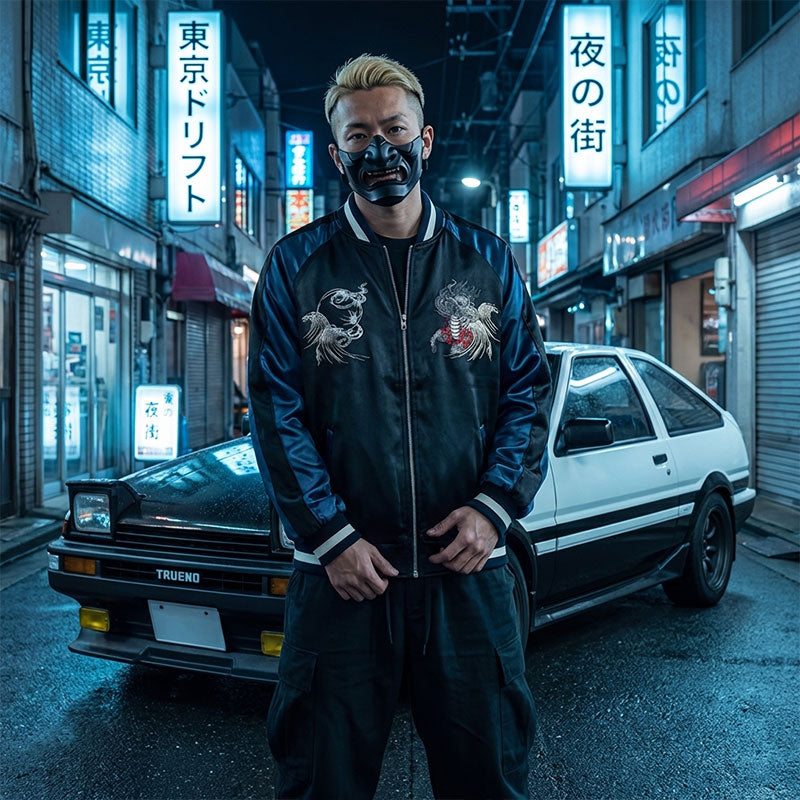 Person in a black Souvenir Jacket with japanese Kirin designs standing in front of a car on a Tokyo neon-lit street.