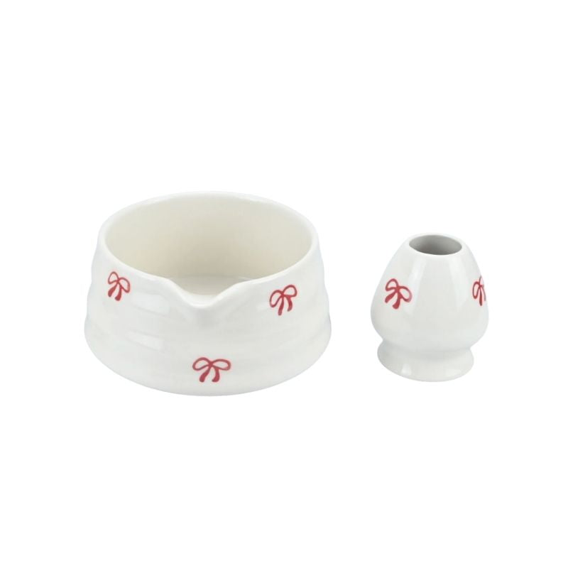 White ceramic container with red decorative elements on a white background