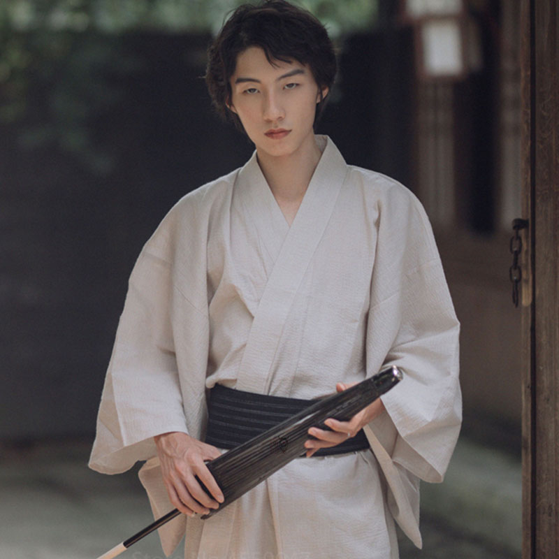 Explore our elegant japanese clothing collection featuring the white kimono men, designed for traditional ceremonies and modern formal events. The man is also wearing a samurai obi belt
