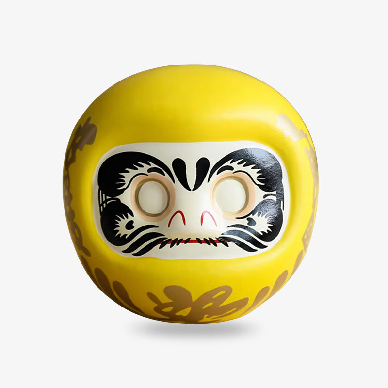 The yellow Daruma represents prosperity and financial success, bringing wealth and fortune.