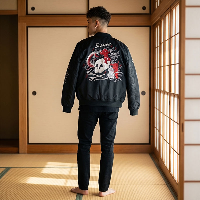 Person wearing a black yokosuka souvenir jacketwith a skull design in a traditional Japanese room.