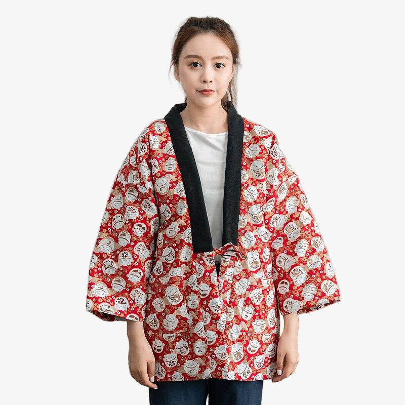 Woman wearing a red Neko Hanten coat with white Japanese lucky cat patterns on a white background
