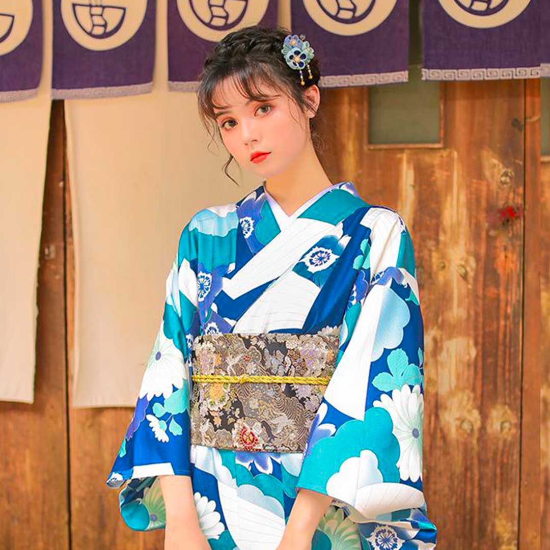 Frontal close-up of kimono showing crossover neckline with asymmetrical white and teal color blocking design.
