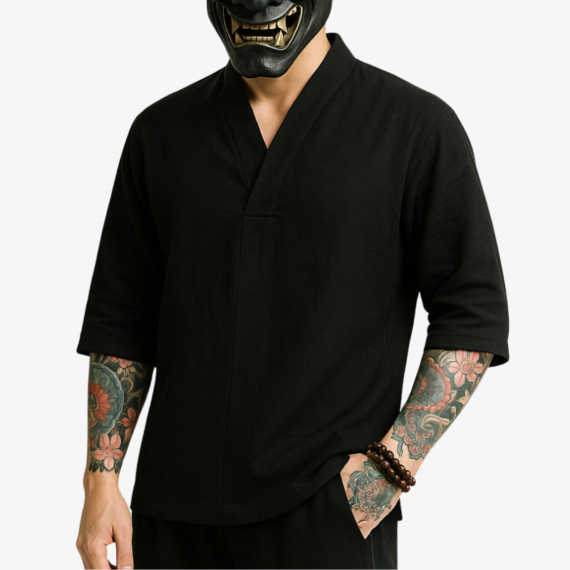 Person wearing a black Japanese Shirt v Neck with a black Oni mask on a white background.