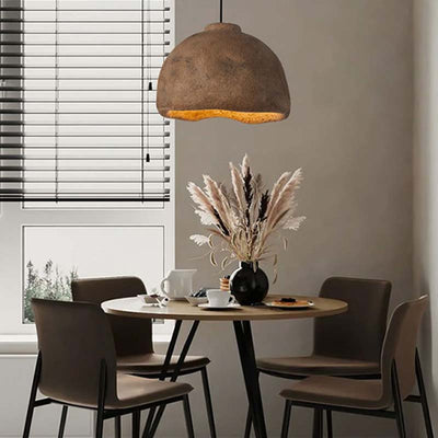 A brown Japanese chandelier with a wood table and four chairs