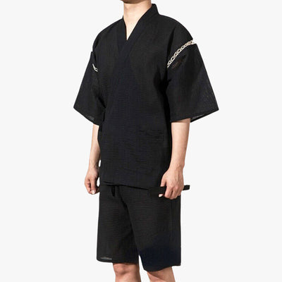 A man is dressed in a Japanese jinbei outfit. This is a traditional Japanese top and cotton kimono shorts.