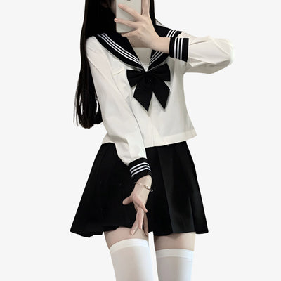 a girl is dressed with Japanese Sailor Uniform with black japanese skirt, black japanese ribboon, and white japanese student shirt