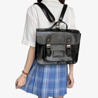 A student wears a black Japanese school bag on her back. She is dressed in a sailor fuku. The Japanese uniform for female students. The vintage Japanese bag is made of leather