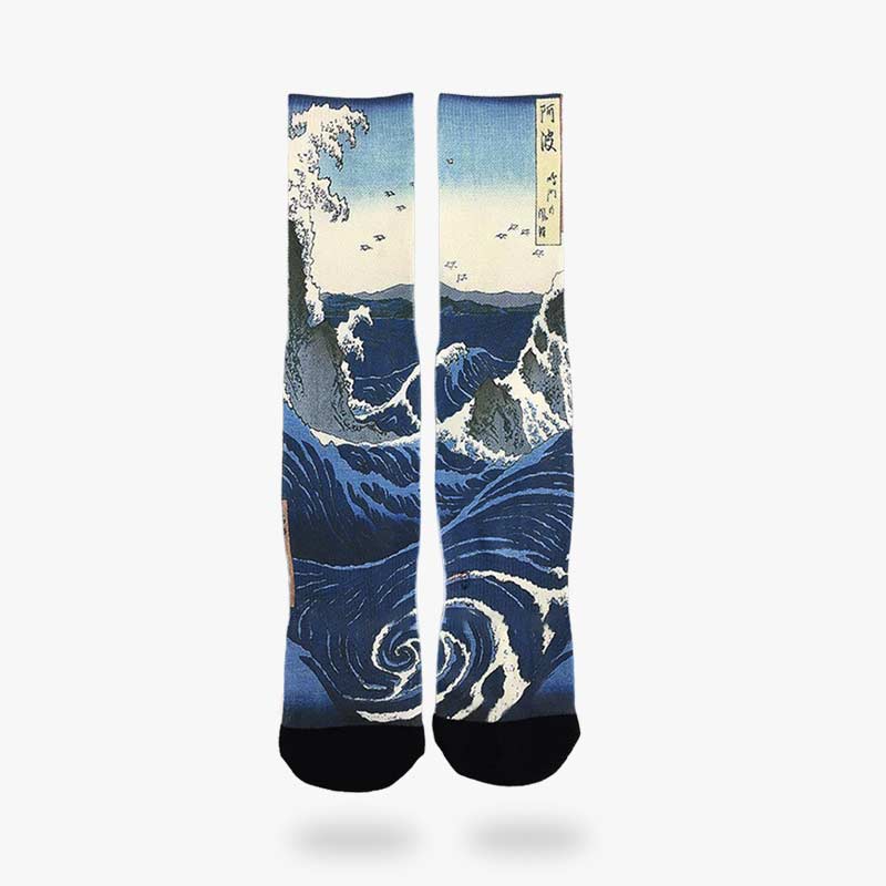 Japanese wave socks are blue with a design printed on cotton of the great wave of kanagawa by the artist Hokusai.