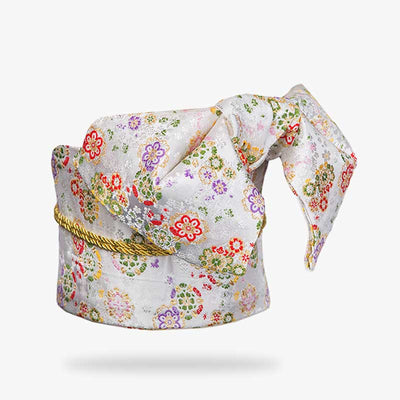 The japanese kimono obi belt is embroidered with sakura flowers motifs. The geisha obi knot holds the traditional women kimono