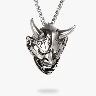 This Japanese pendant features the head of an Oni demon with horns and teeth. The colour is silver and so is the chain.