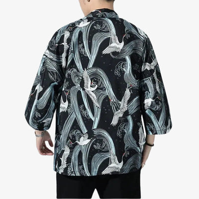 Person wearing a black kimono Cranes with white Japanese birds and wave design on a white background