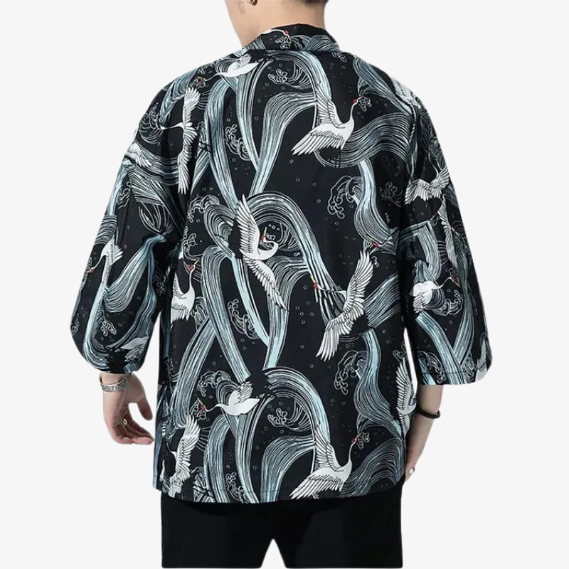 Person wearing a black kimono Cranes with white Japanese birds and wave design on a white background