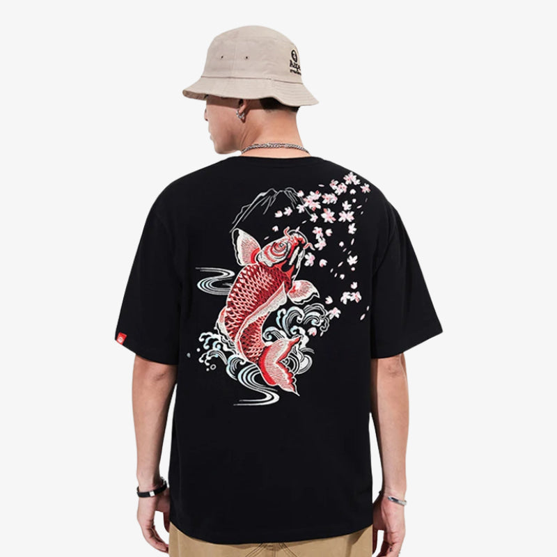 Person wearing a black Koi t-shirt with a Japanese fish design on the back, standing against a white background.
