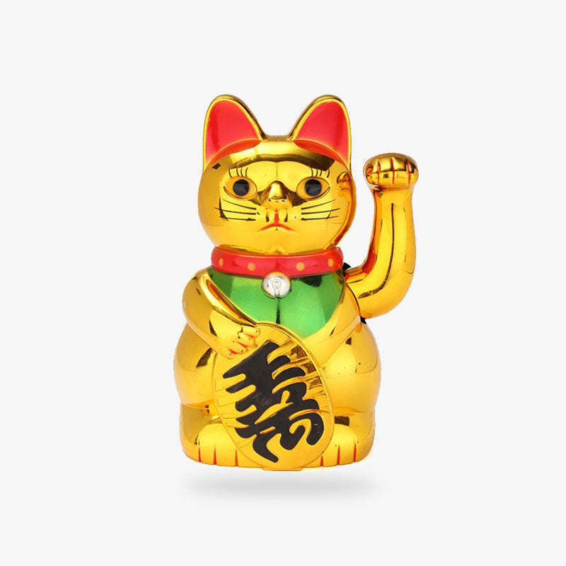 A  Maneki Neko Gold lucky cat has its left paw raised and is holding a gold coin in its right paw. He has a red collar around his neck and is standing on his paws.