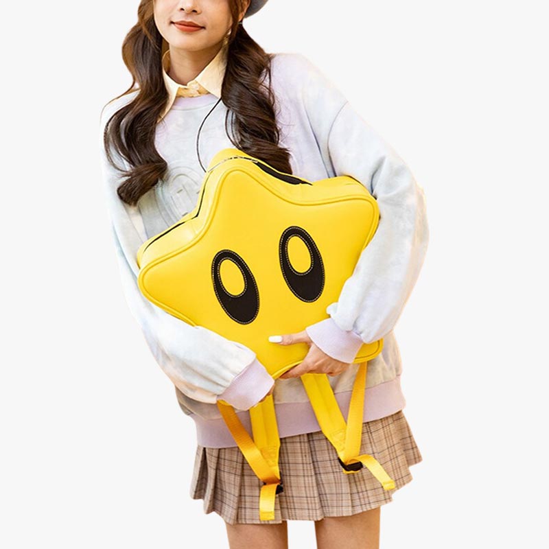 A woman is holding a yellow star-shaped backpacks-kawaii. Cute Japanese backpack for Harajuku outfits