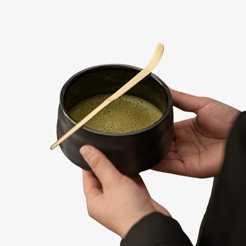 Bamboo chashaku, a handcrafted scoop for precise matcha measurement, perfect for tea enthusiasts. the men is holding a matcha bowl