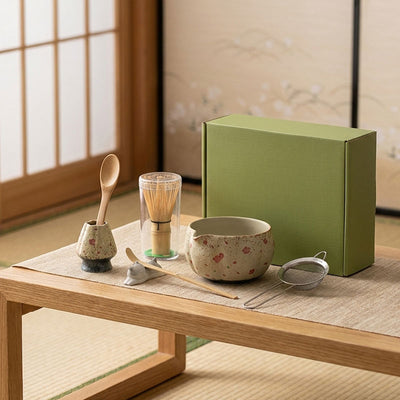 A beautiful matcha set with a green box on a wooden table in a traditional Japanese room.