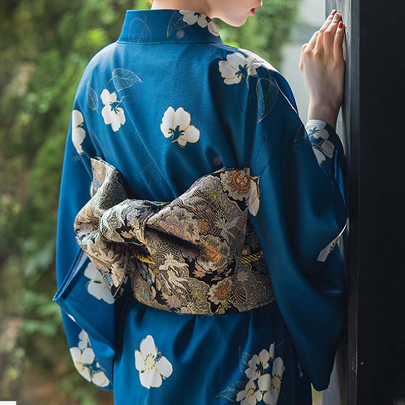 a women is dressed with a belt japanese embroidered with japanese pattern and a traditional kimono for women