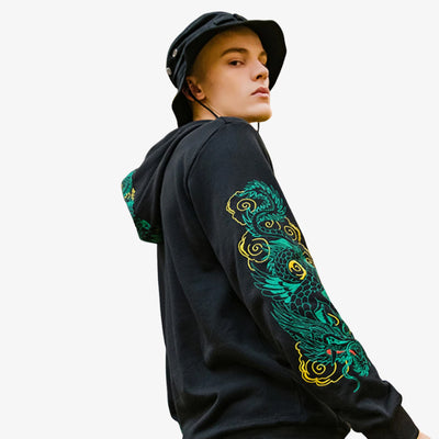 Person wearing a black Japan hoodie with green and yellow dragon design on a white background
