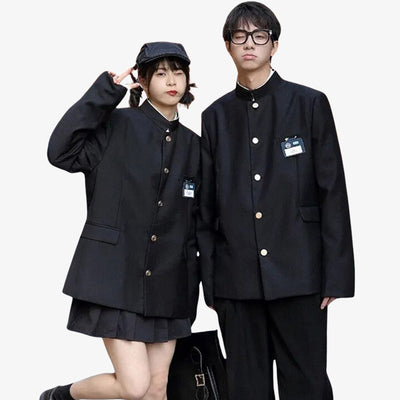 A japanese couple is dressed with black gakuran jacket. The girl wear a japanese black skirt and the man wear a japanese black pant