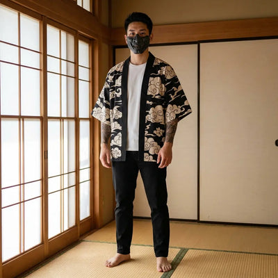 Man wearing a black haori jacket in a traditional Japanese washitsu room, front view